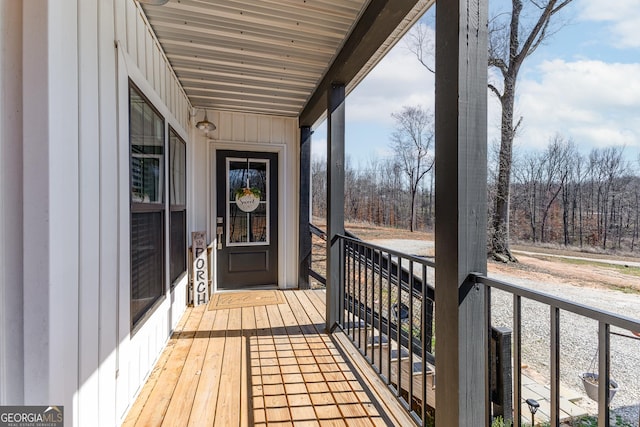 balcony featuring a forest view