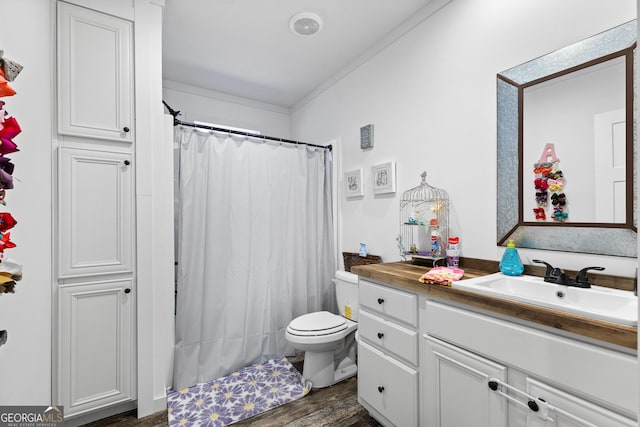 full bathroom with visible vents, a shower with shower curtain, toilet, vanity, and wood finished floors