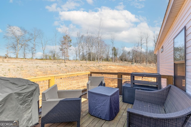 wooden deck featuring a grill