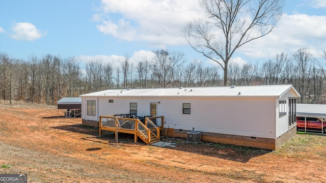 rear view of house featuring crawl space, metal roof, a deck, and central AC unit