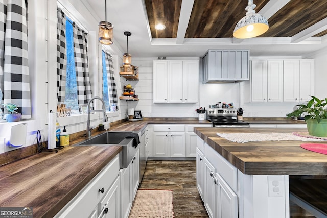 kitchen with butcher block counters, dark wood-type flooring, white cabinetry, a sink, and stainless steel electric range