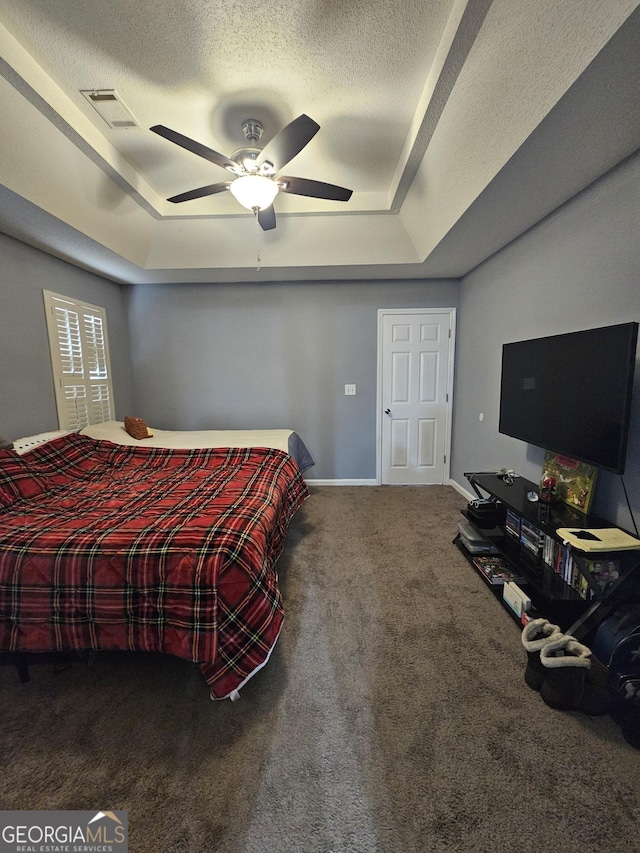 1722 Harrogate Dr, Augusta, GA 30906 - carpeted bedroom featuring a raised ceiling, visible vents, a ceiling fan, a textured ceiling, and baseboards