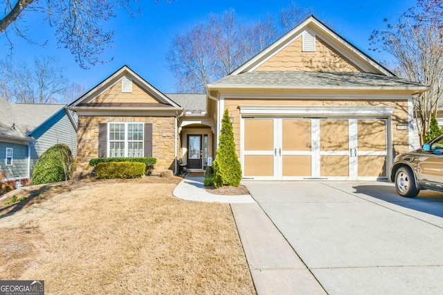 ranch-style home with a garage, stone siding, roof with shingles, and driveway