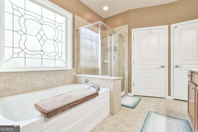 bathroom with vanity, a shower stall, a bath, and tile patterned floors