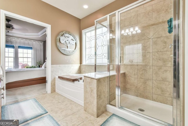 ensuite bathroom with ensuite bathroom, tile patterned flooring, a shower stall, and a garden tub