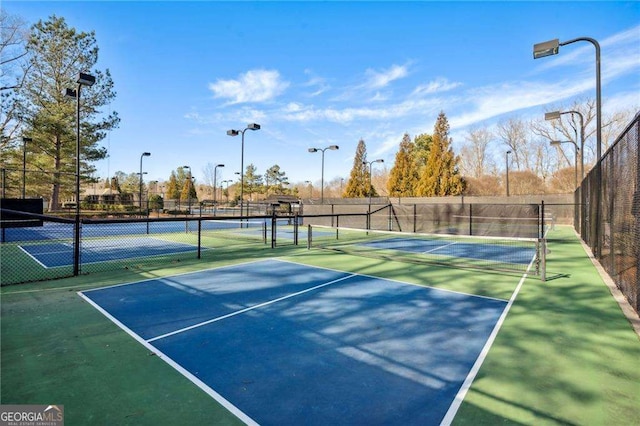 view of sport court featuring fence