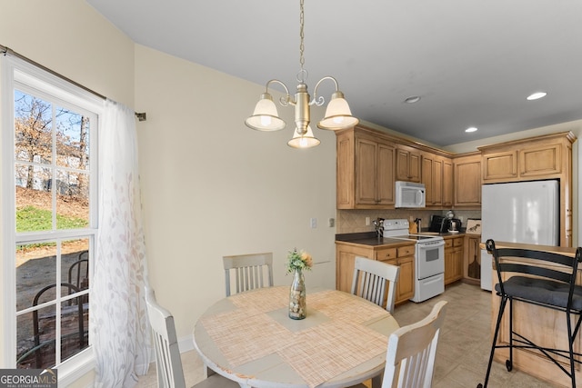 dining room featuring a chandelier, light tile patterned floors, and recessed lighting