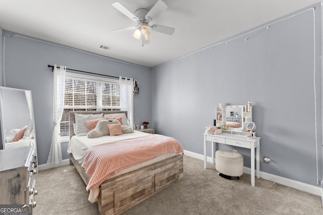 carpeted bedroom with a ceiling fan, visible vents, and baseboards