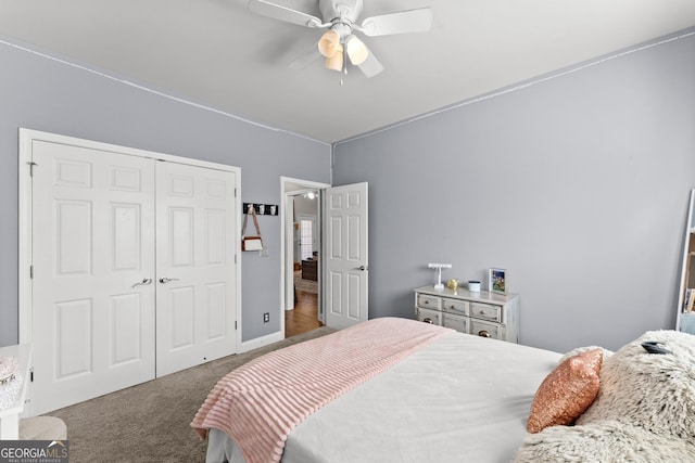 bedroom with a ceiling fan, carpet, a closet, and baseboards