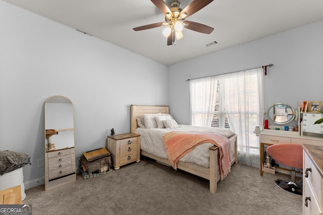 carpeted bedroom with ceiling fan and visible vents