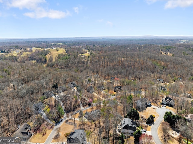 birds eye view of property with a wooded view