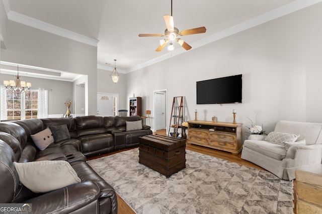 living room featuring ornamental molding, wood finished floors, and ceiling fan with notable chandelier