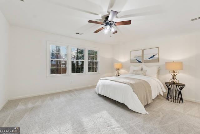 carpeted bedroom with baseboards, visible vents, and ceiling fan