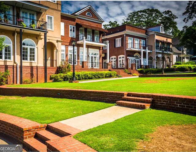 exterior space featuring a front lawn and brick siding