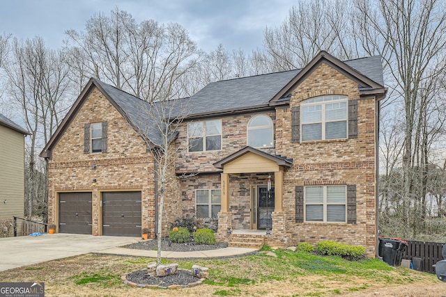 traditional-style house with a garage, brick siding, fence, concrete driveway, and roof with shingles