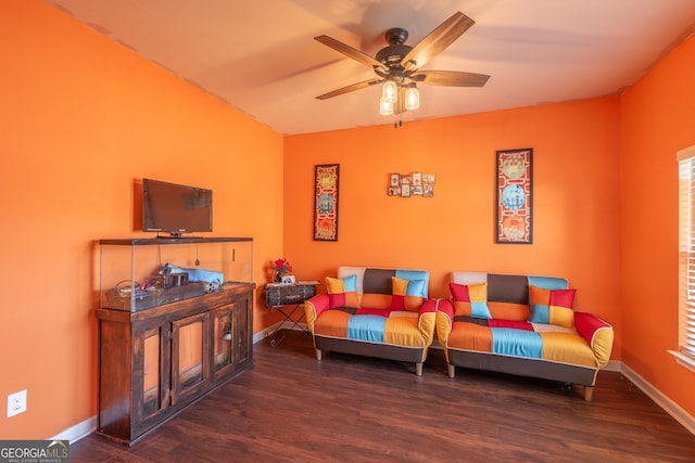 living area with a ceiling fan, baseboards, and wood finished floors