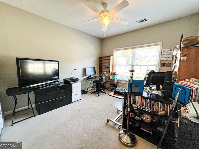 office area with baseboards, visible vents, a ceiling fan, and carpet