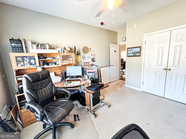 carpeted office space with baseboards and ceiling fan