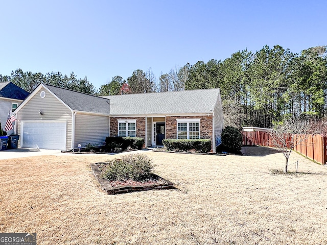 single story home with an attached garage, concrete driveway, and fence