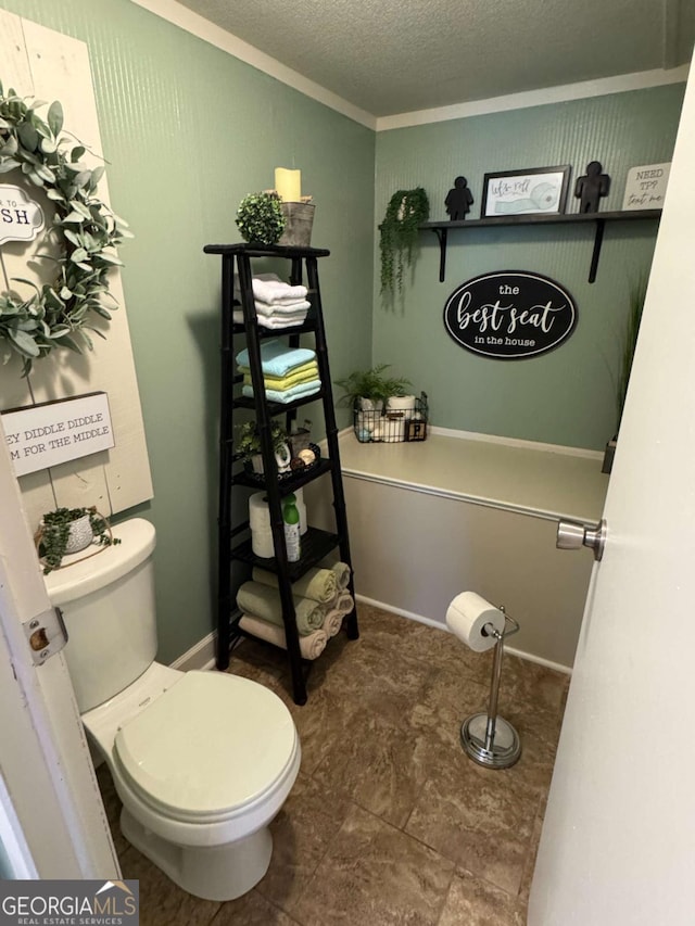 bathroom with toilet and a textured ceiling