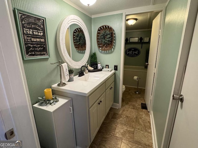 bathroom featuring vanity, toilet, and a textured ceiling