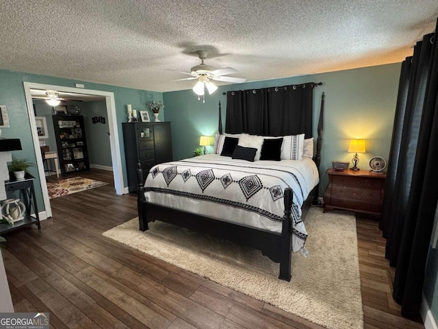 bedroom featuring a textured ceiling, ceiling fan, hardwood / wood-style floors, and baseboards