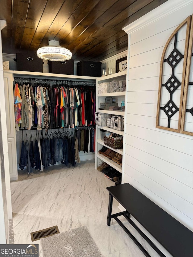 spacious closet with marble finish floor and visible vents