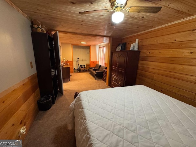 bedroom featuring wood ceiling, light carpet, and wooden walls