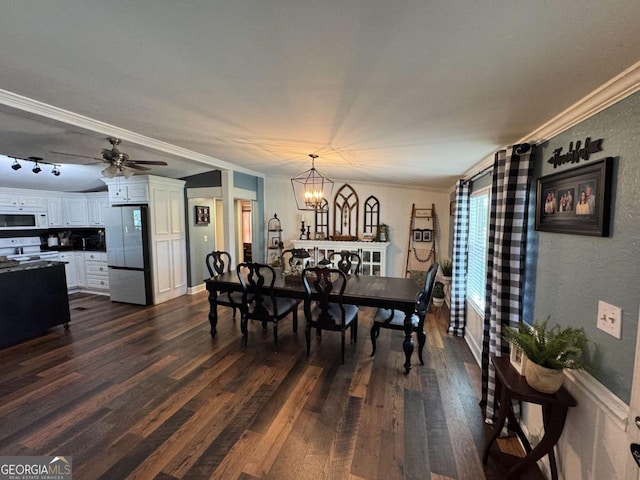 dining room featuring ornamental molding, dark wood finished floors, and ceiling fan with notable chandelier