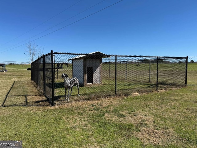 view of yard featuring an outdoor structure and fence