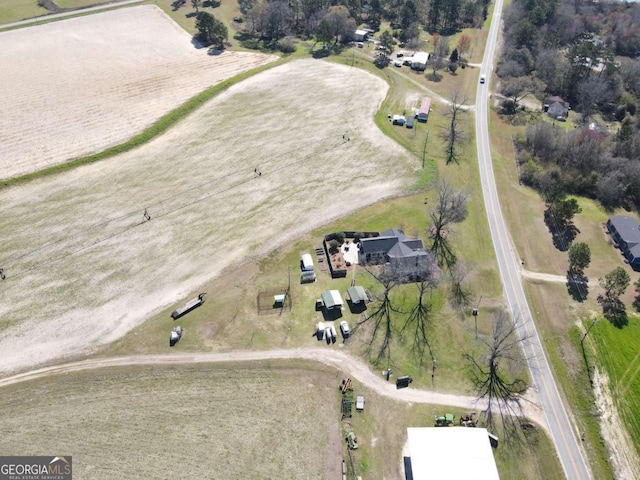 birds eye view of property with a rural view