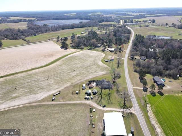 birds eye view of property with a rural view