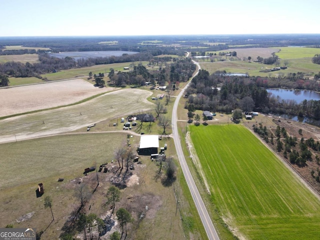 birds eye view of property with a rural view and a water view