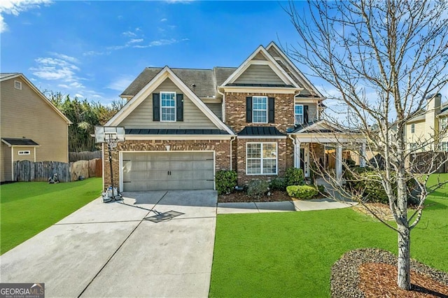 craftsman-style home with brick siding, concrete driveway, a front yard, a standing seam roof, and fence