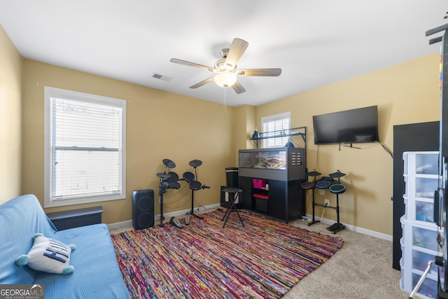 interior space featuring a ceiling fan, carpet flooring, visible vents, and baseboards