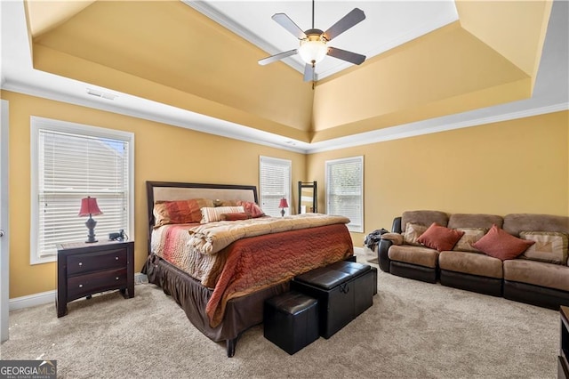 bedroom with ceiling fan, carpet floors, visible vents, a tray ceiling, and crown molding