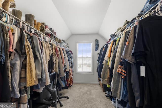 spacious closet with vaulted ceiling and carpet floors