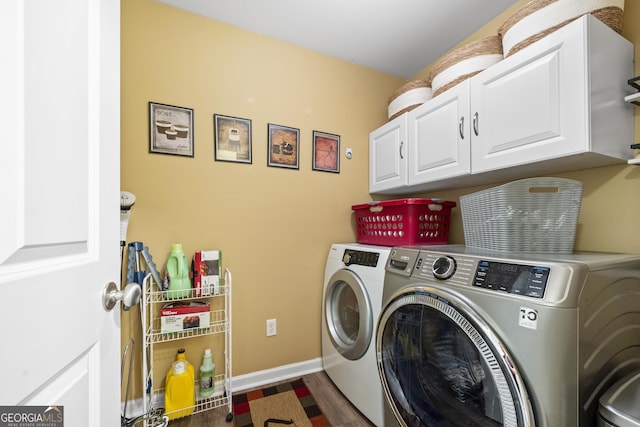 clothes washing area with washing machine and dryer, baseboards, dark wood-type flooring, and cabinet space