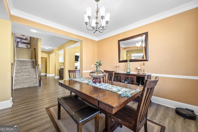 dining room featuring stairs, wood finished floors, baseboards, and an inviting chandelier