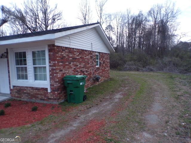 view of home's exterior featuring brick siding