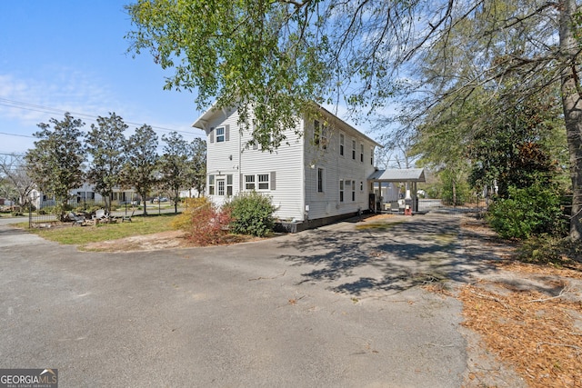 view of home's exterior with aphalt driveway