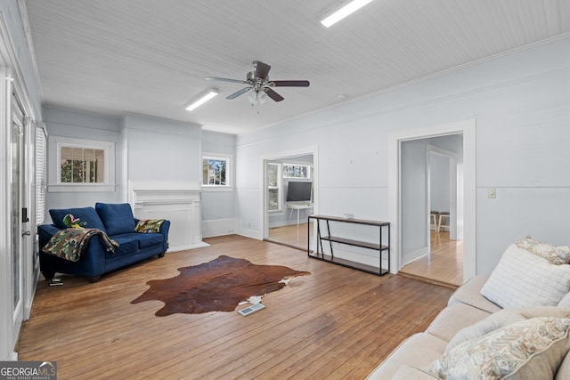 living room featuring visible vents, ceiling fan, and hardwood / wood-style flooring