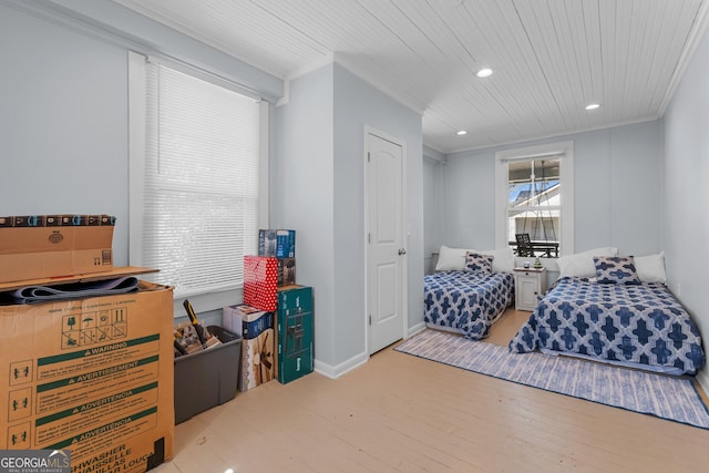 bedroom featuring crown molding, baseboards, wood finished floors, and recessed lighting