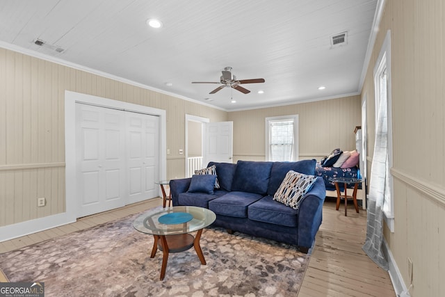 living area featuring crown molding, recessed lighting, wood-type flooring, visible vents, and ceiling fan