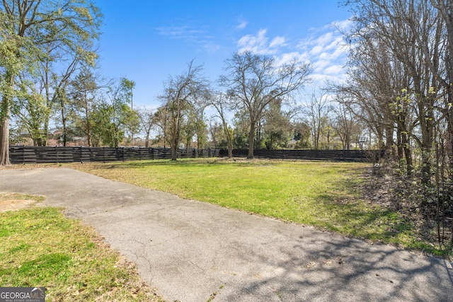 view of yard with a rural view and fence