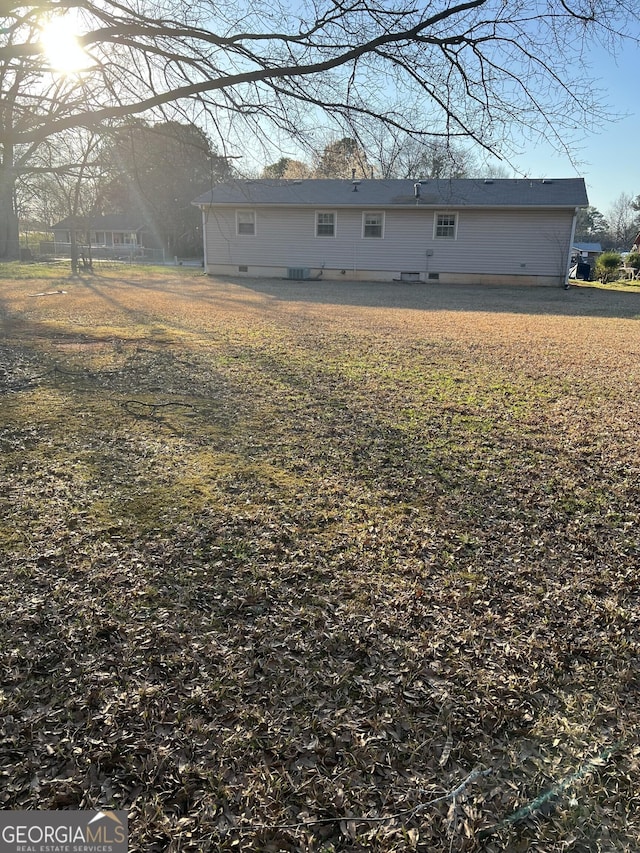 rear view of property with crawl space