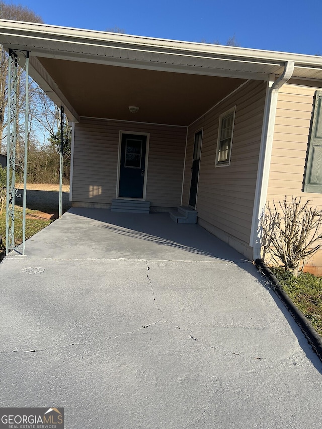 entrance to property with an attached carport