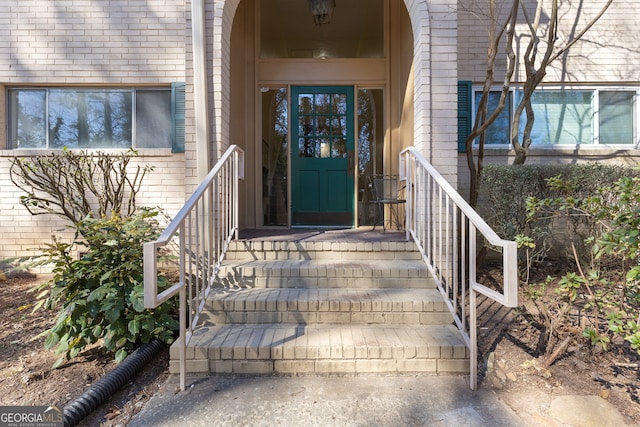 property entrance with brick siding