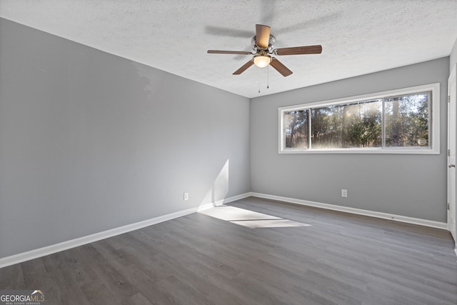 spare room featuring a ceiling fan, a textured ceiling, baseboards, and wood finished floors