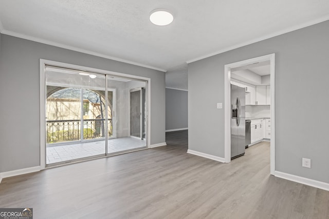 unfurnished living room featuring light wood-type flooring, baseboards, and ornamental molding